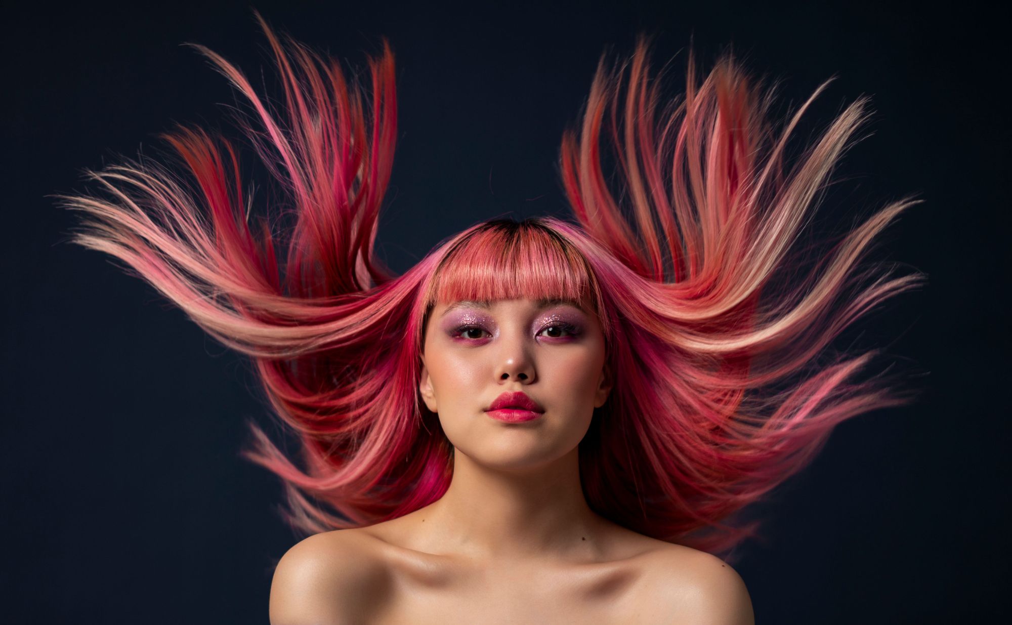 Portrait of a woman with vivid pink hair in motion